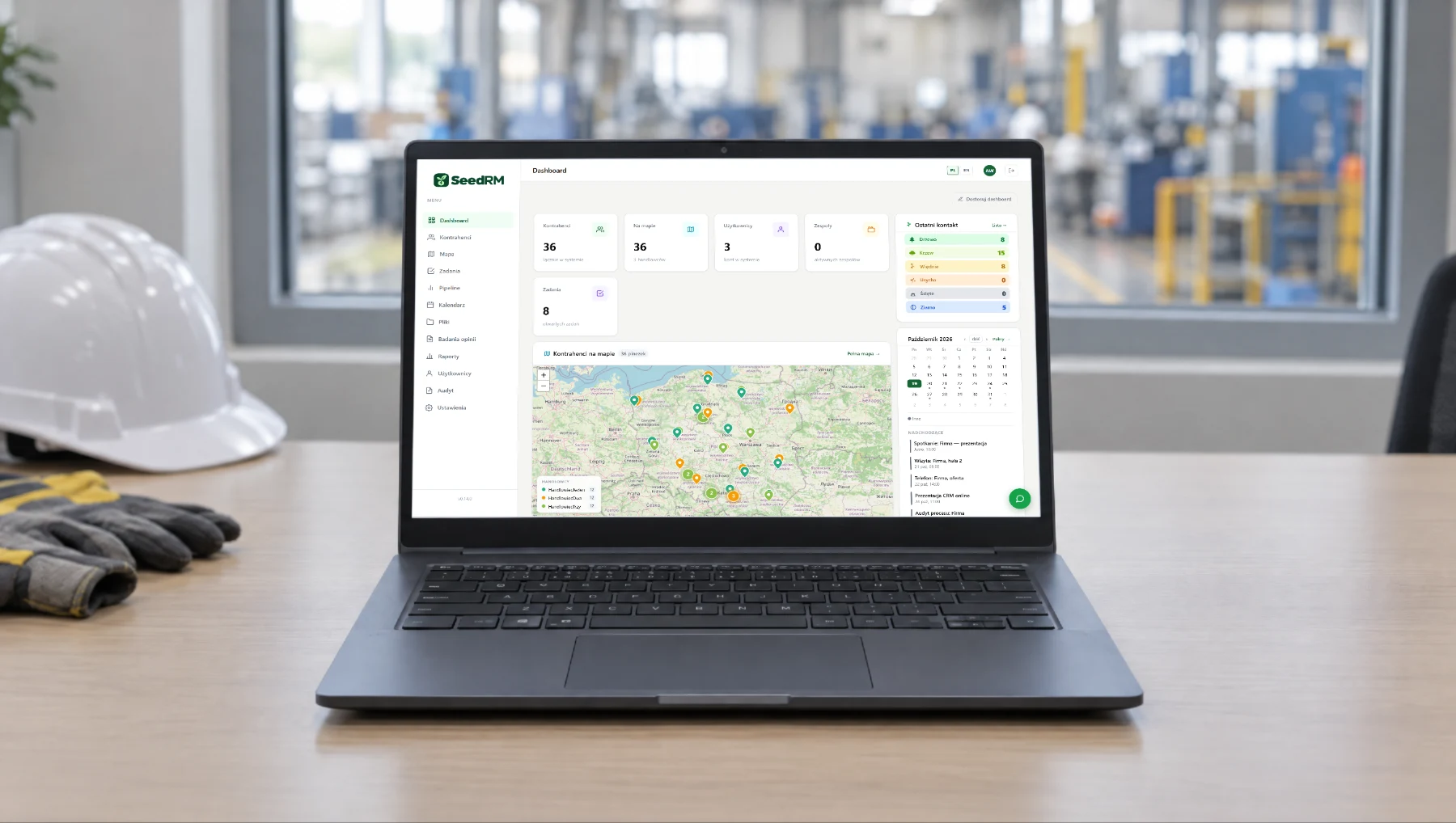 A laptop with the SeedRM dashboard: customer map, counters, calendar.